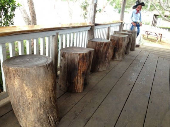 Five large wooden stumps as Hawaiian Country Store front porch chairs