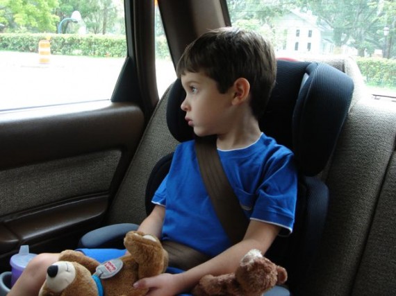 young child in car seat with stuffed animals