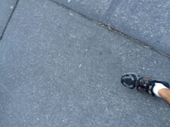 One foot step on NYC sidewalk