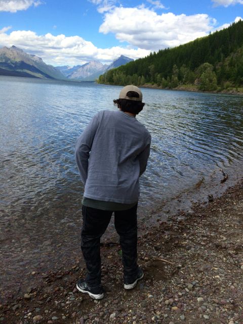 Teen learning to skip a stone at Lake Mcdonald