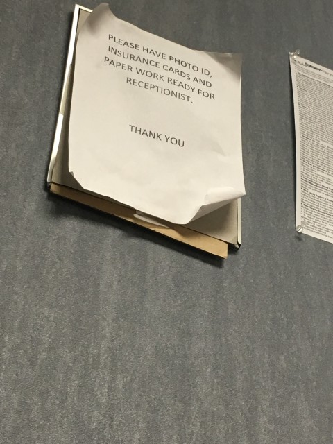 Tattered sign in medical office