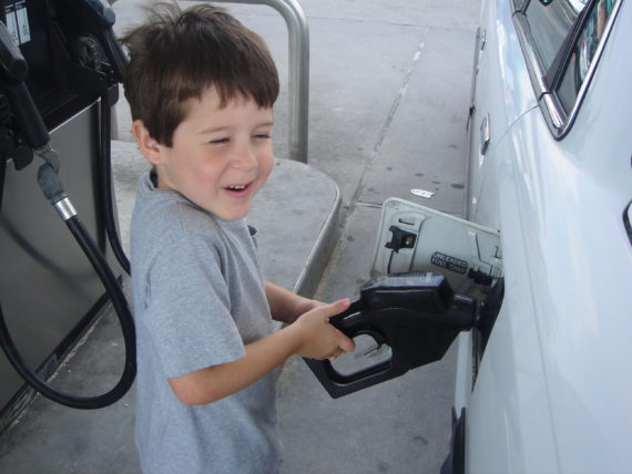 small child pumping gas