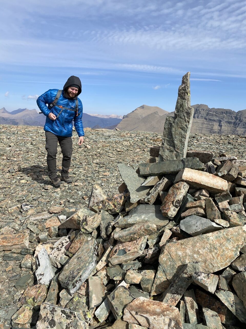 mountains and a guy near a rock pile