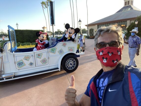 jeff noel with Mickey and Minnie riding in a parade car at Epcot