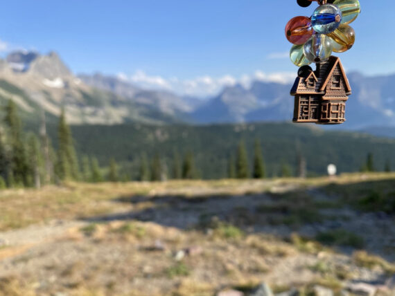 Small house toy with beads in mountains