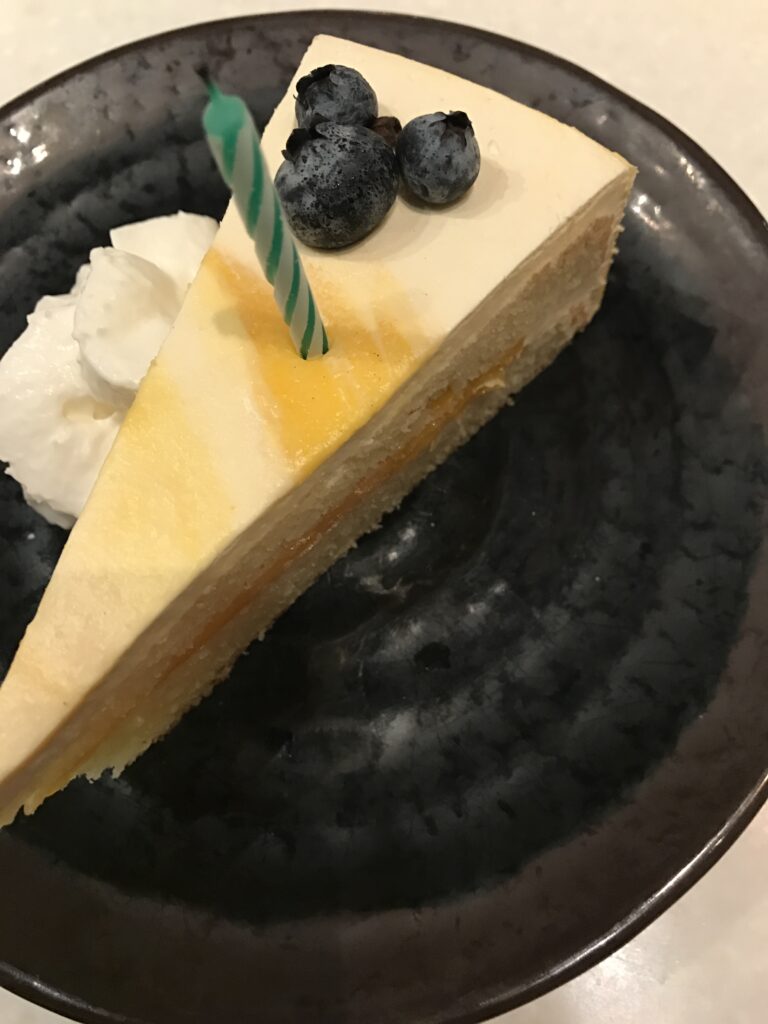 cheesecake slice with a hidden Mickey made from three blueberries 