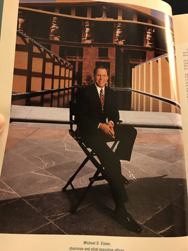 Michael Eisner sitting on a director's chair