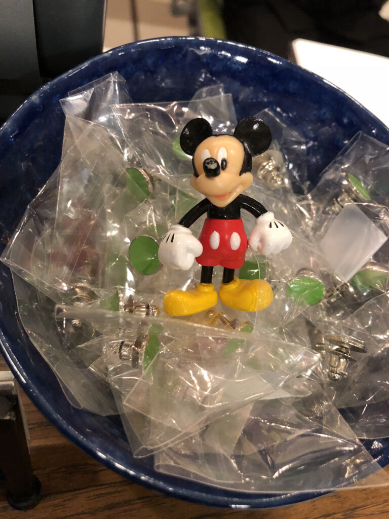 Mickey Mouse toy in a small bowl of lime green dots