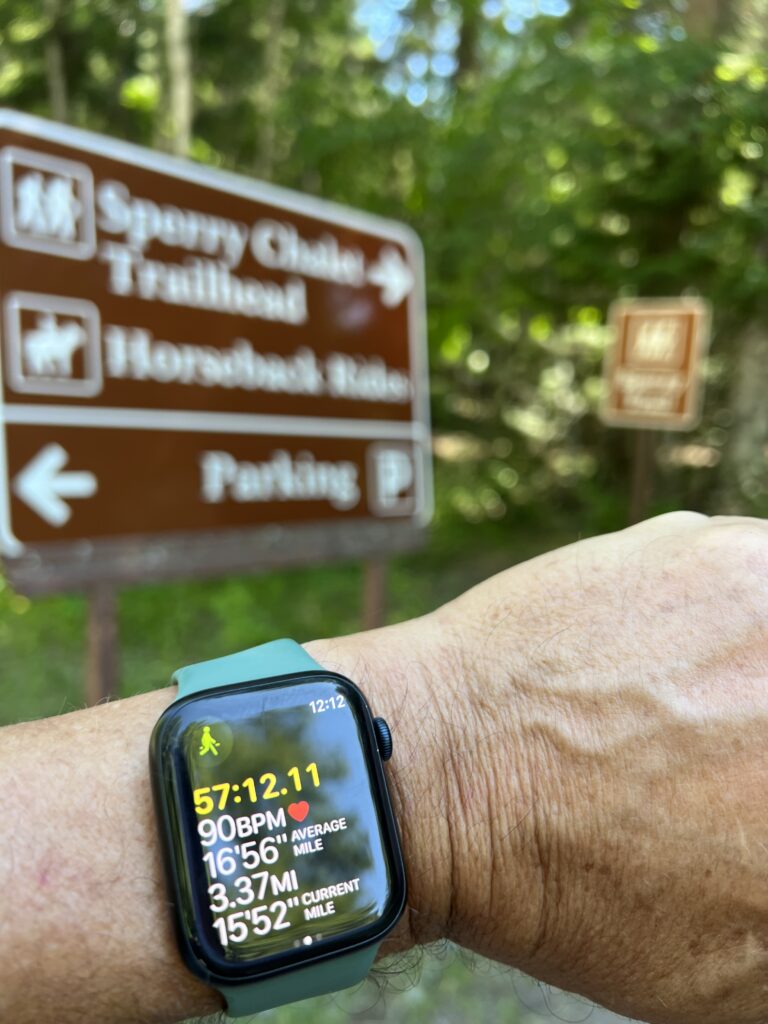 Apple Watch on her wrist at a hiking trail