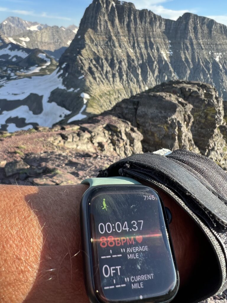 Apple Watch on a person’s wrist in the mountains