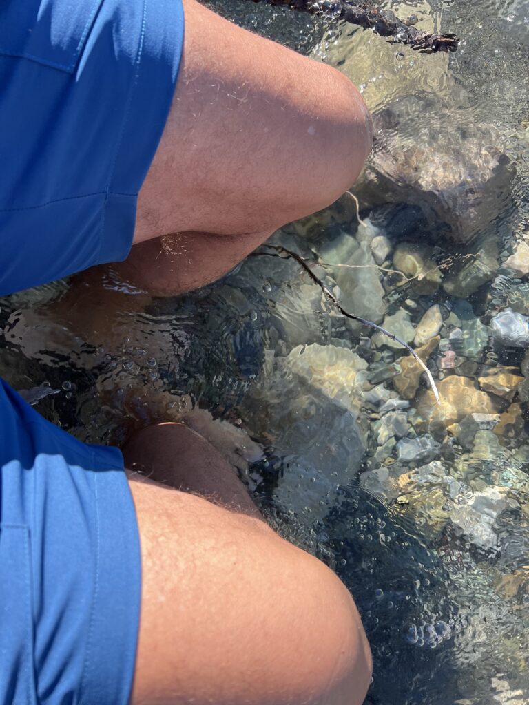 Man with feet in a creek
