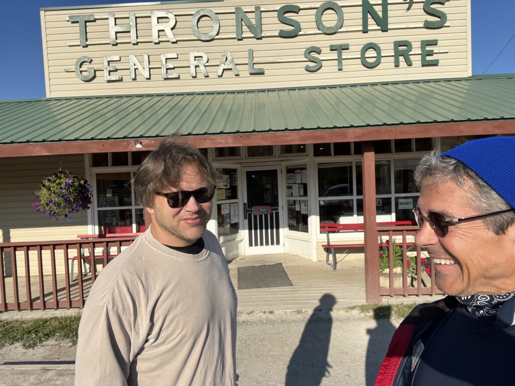 Two men in front of a general store