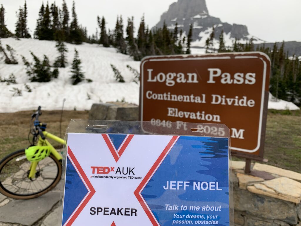 TEDx Speaker name tag at a Mountain Pass welcome sign