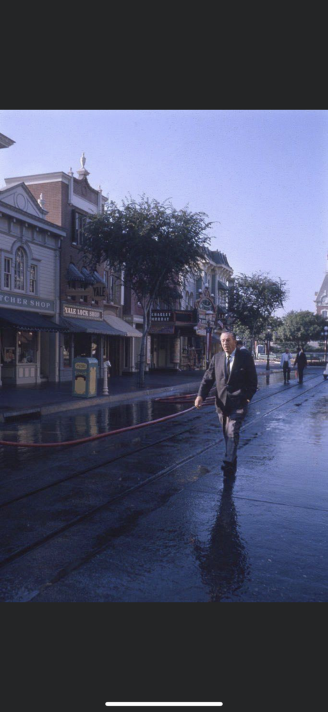 Walt Disney walking on an empty Main Street at Disneyland 
