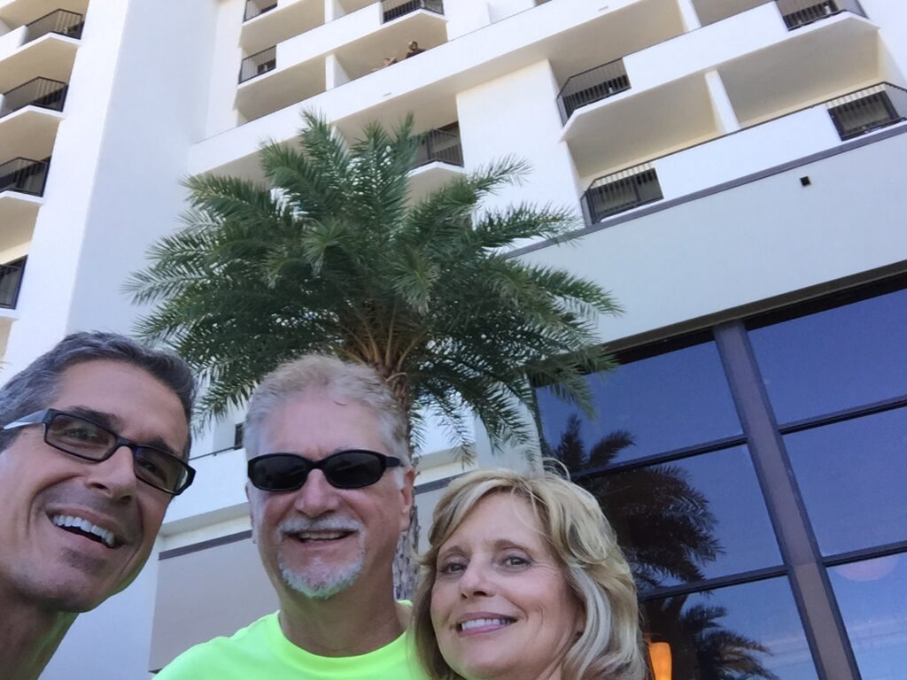 three adults posing for a selfie
