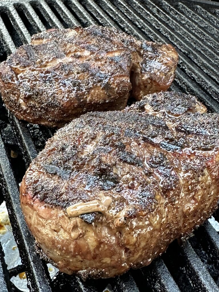 Two steaks on a grill