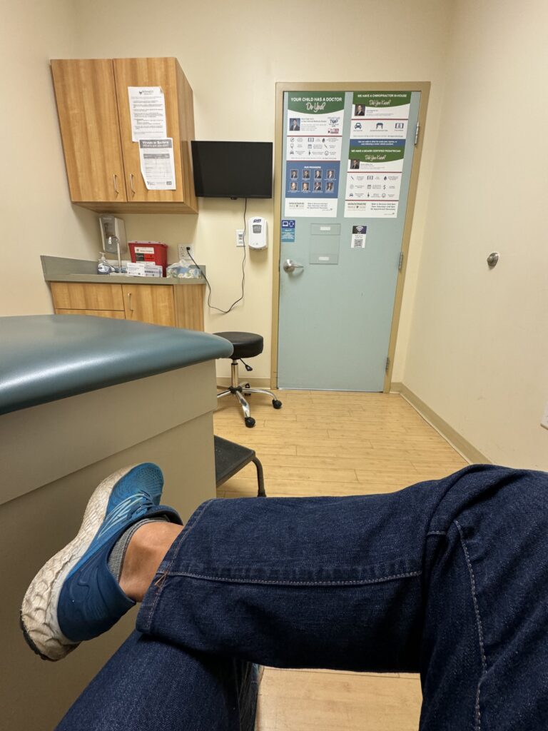 Person sitting in a doctors exam room