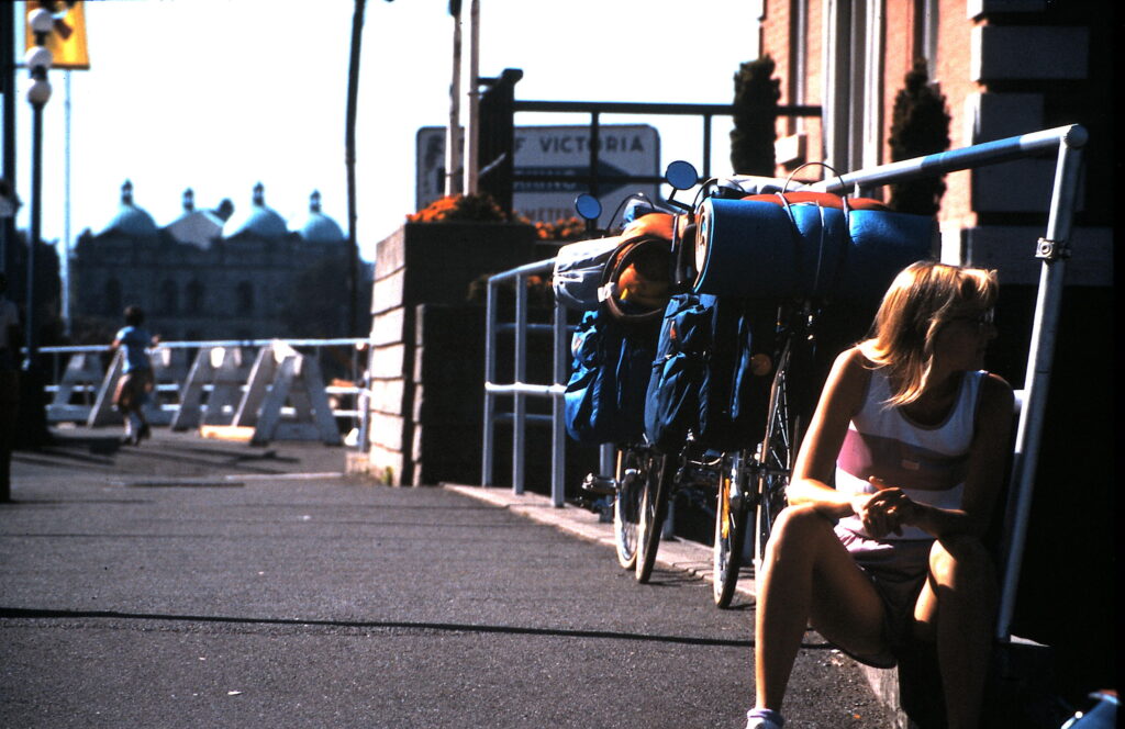 Woman sitting next to touring bicycle