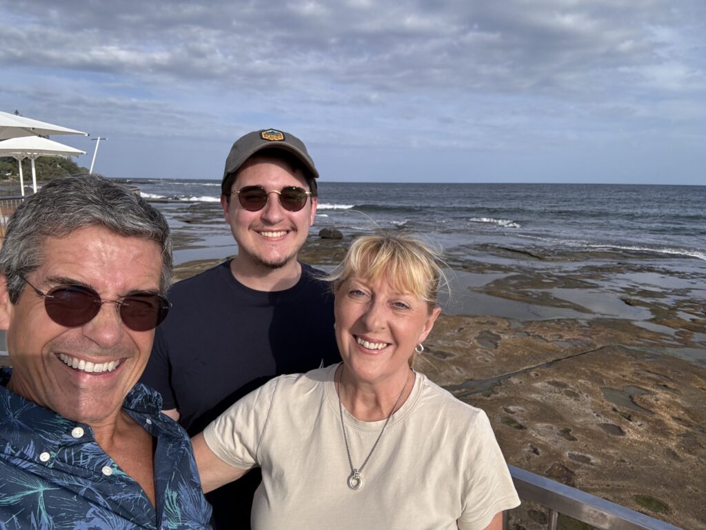 Three people posing at the beach