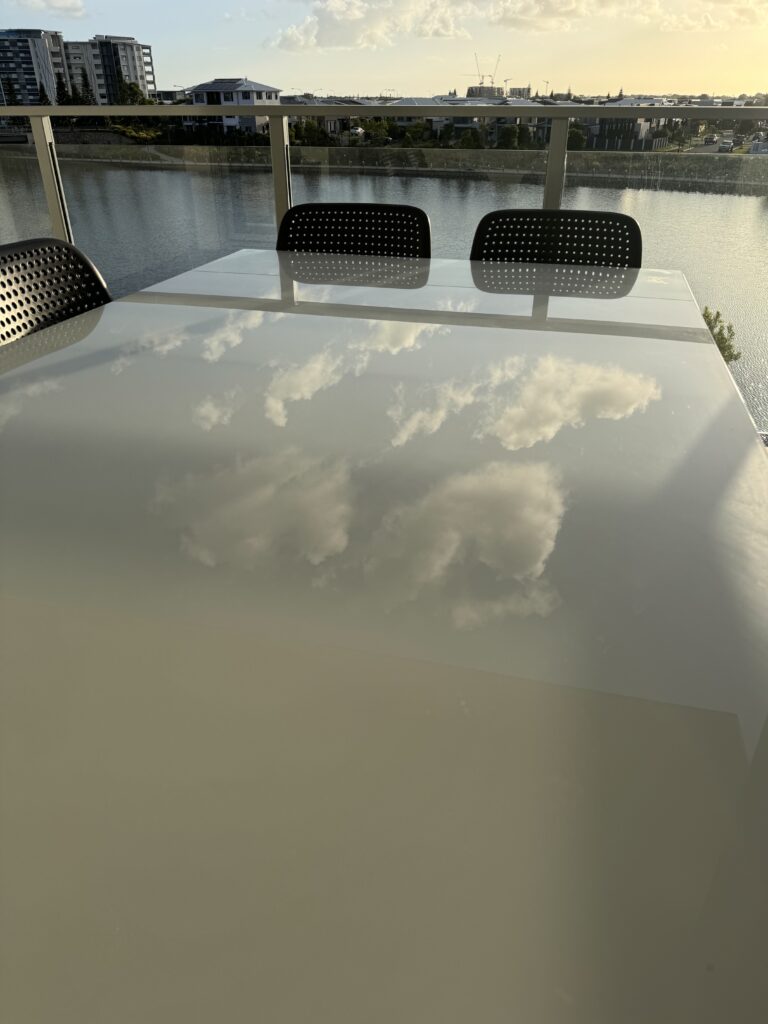 Sky reflecting off of a glass table