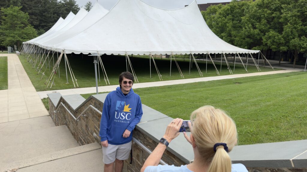 person taking photo of college student