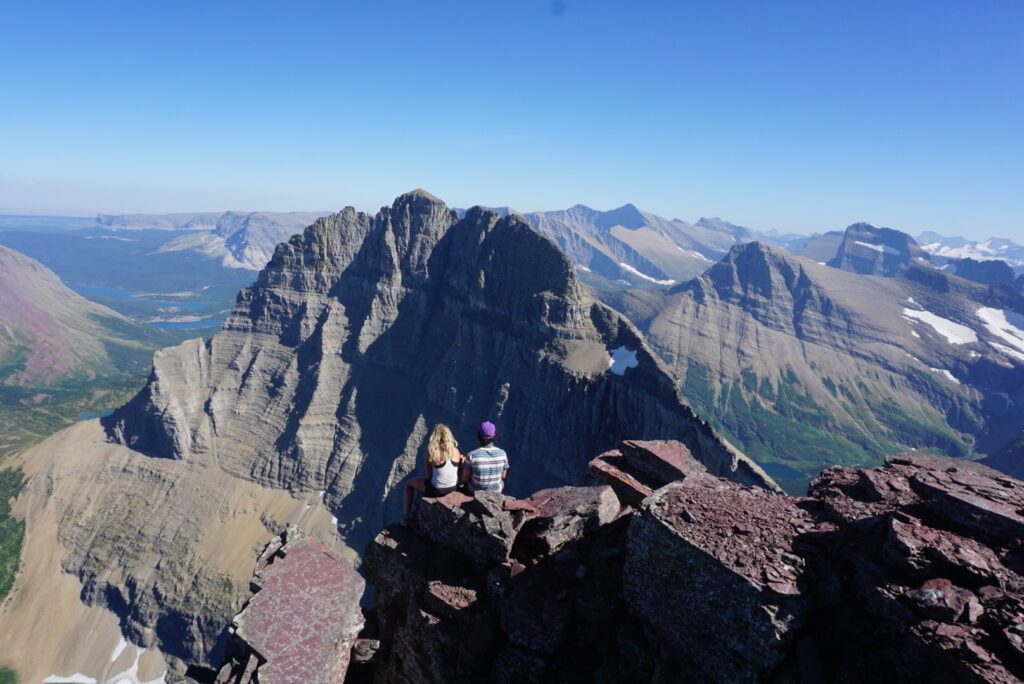 A couple sitting high in the mountains