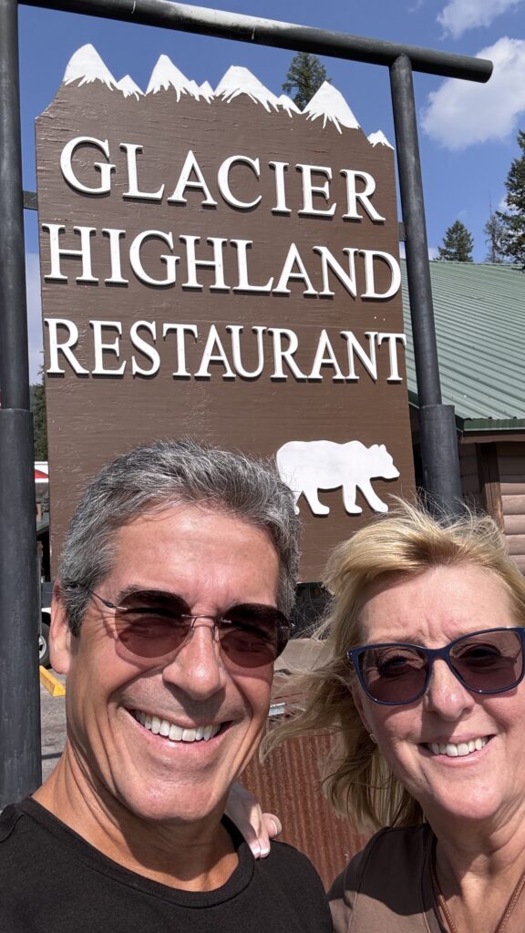 Two people in front of a restaurant saying