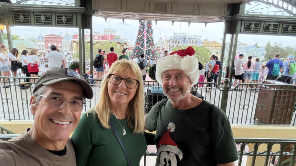 Three people posting in the Magic Kingdom