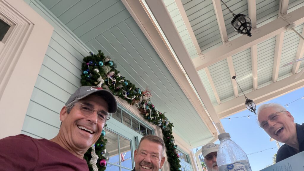 four senior citizens at cafe table
