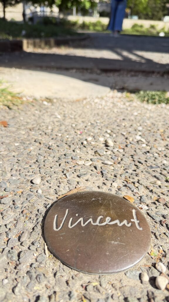 Small geological ground marker labeled Vincent