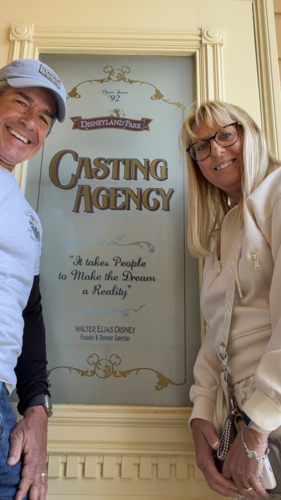Two Disney retirees beside special themed door