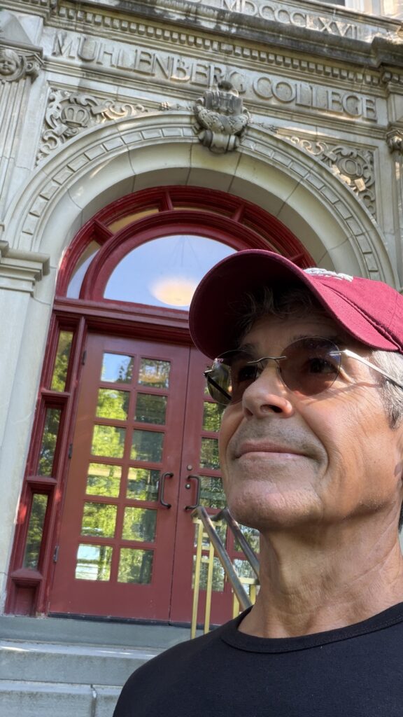 Man in front of college building doors